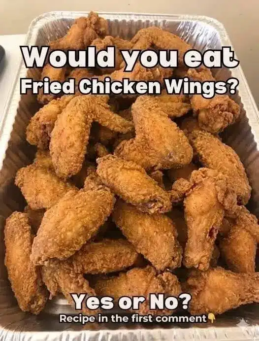 Close up of crispy oven baked chicken wings tossed in spicy buffalo sauce
