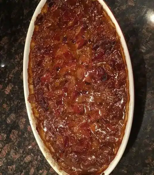 Southern baked beans served in a small bowl as a side dish for a barbecue meal.