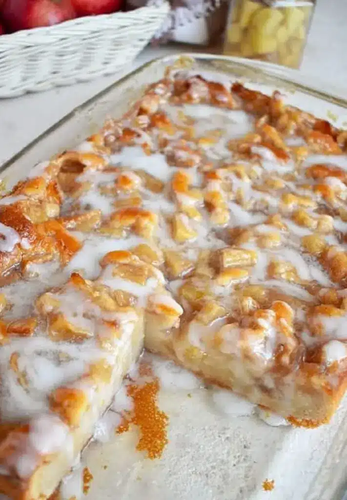 a close up slice of apple coffee cake showing the fruit layer and crumbly top