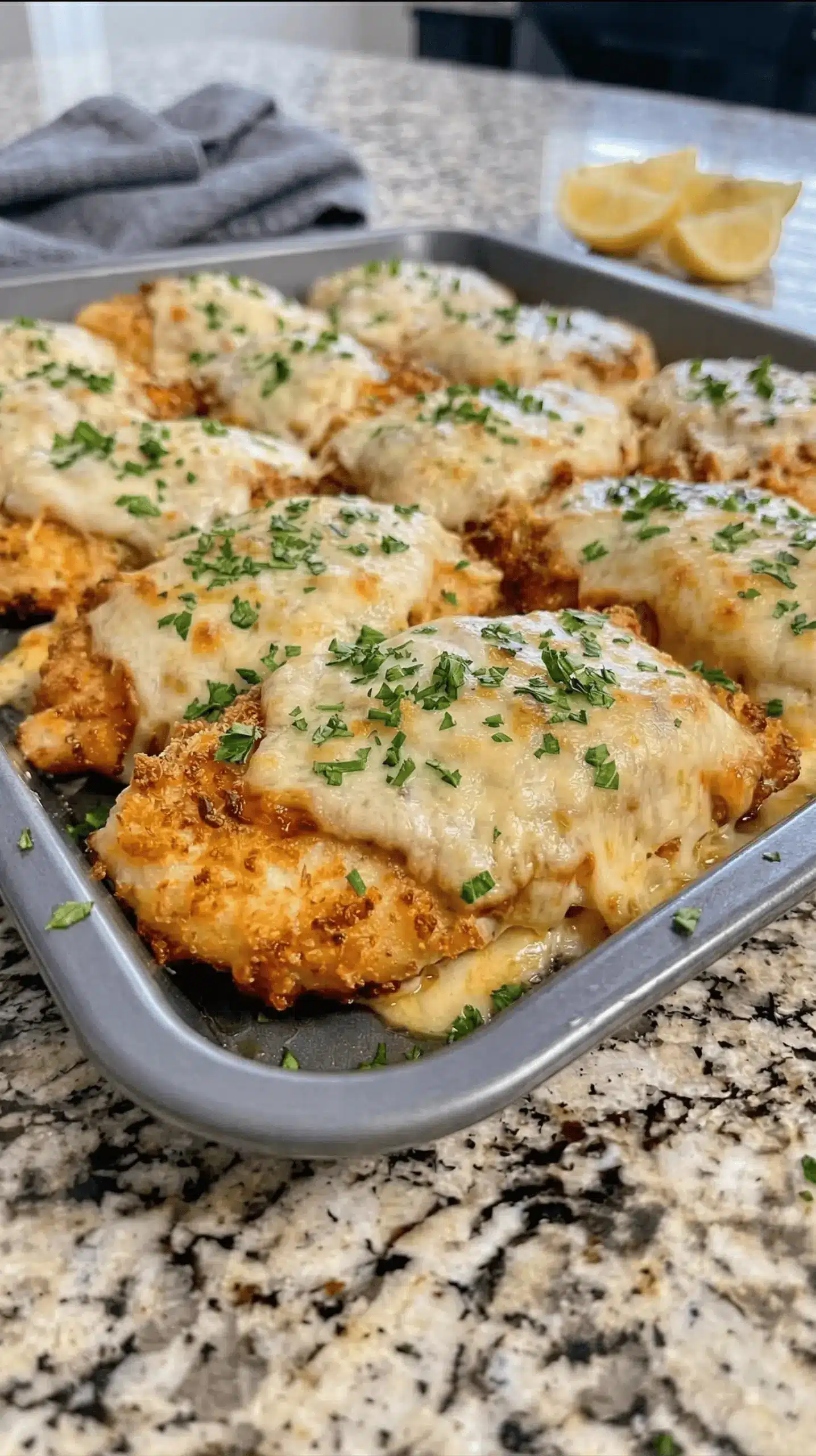 Golden brown baked parmesan mayonnaise chicken served on a white plate