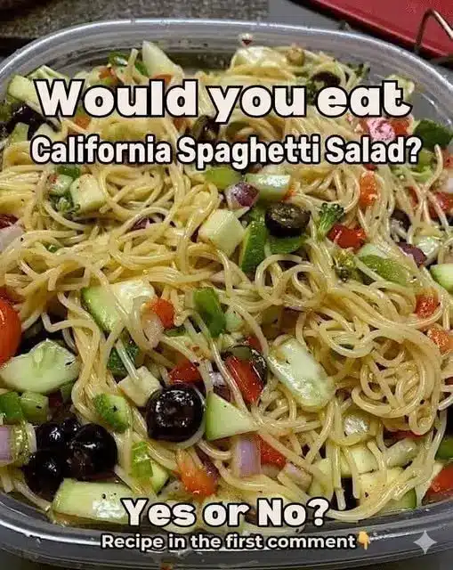 Close up of spaghetti salad with dressing and parmesan cheese