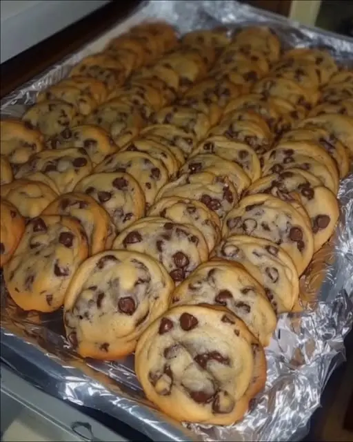 Finished stack of chewy chocolate chip cookies with flaky salt on top