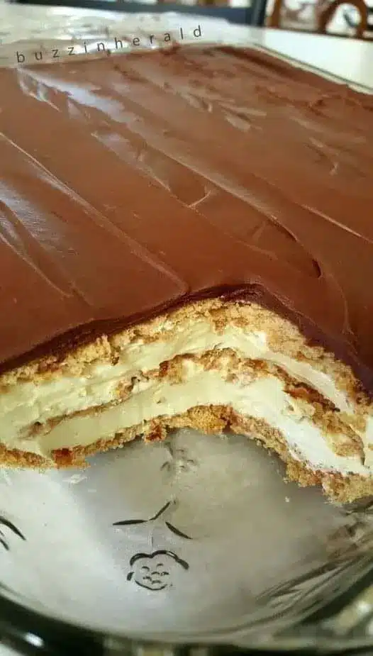 A slice of chocolate eclair dessert on a plate showing the beautiful layers