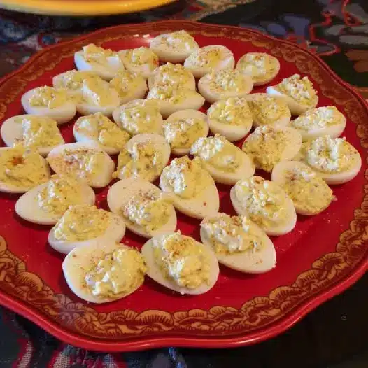 Close up of a single deviled egg showing the smooth texture of the yolk filling