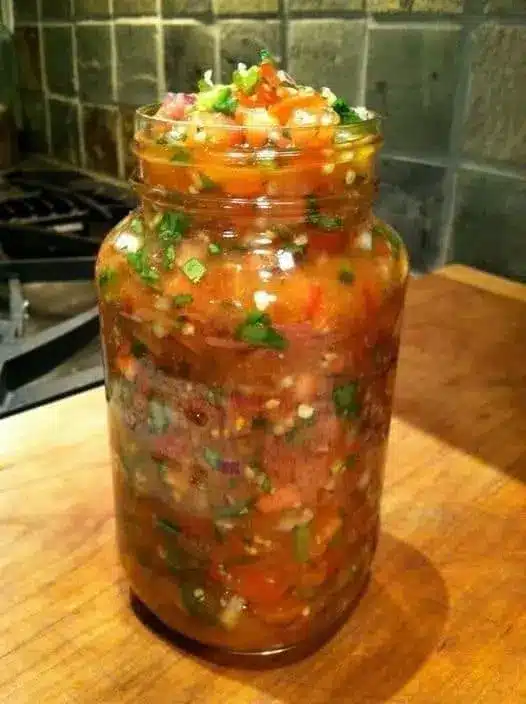 Homemade salsa served in a bowl with tortilla chips on the side