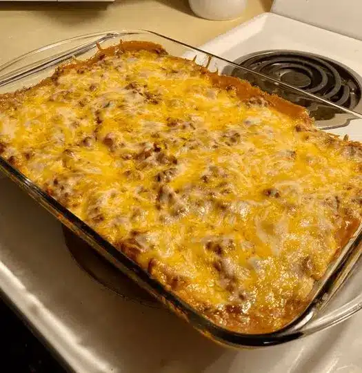A perfectly baked Mexican casserole garnished with fresh cilantro and tomatoes