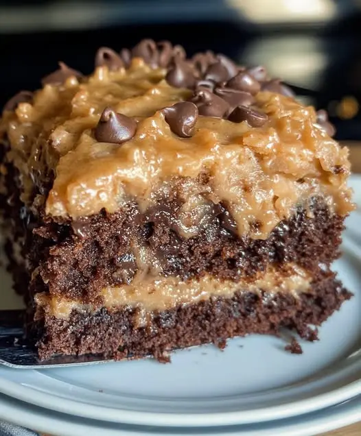A slice of finished German chocolate cake with coconut pecan topping