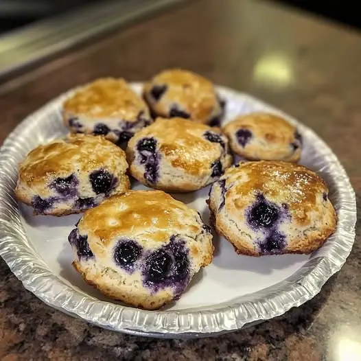 The interior of a blueberry muffin showing a soft, airy crumb and evenly distributed blueberries.