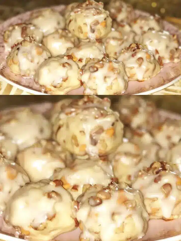 Two butternut cookies broken in half to show the tender, nut-filled interior and the golden, crunchy exterior edges.