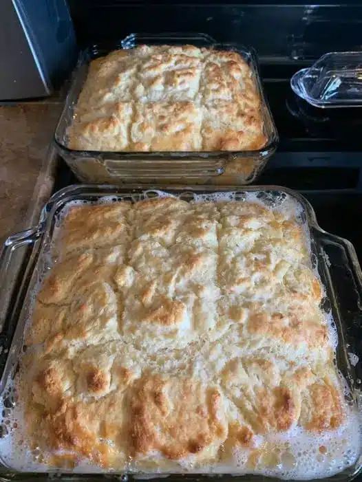 A serving of peach cobbler with a melting scoop of vanilla ice cream on top