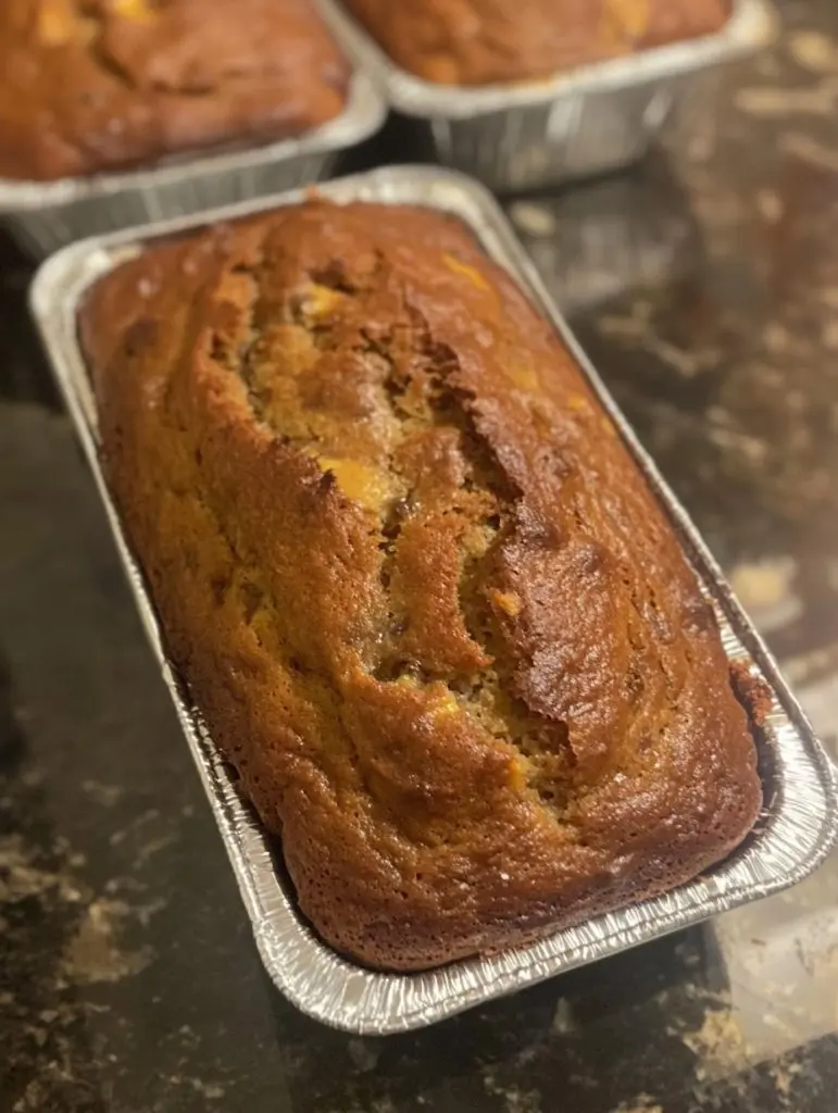 Two slices of moist zucchini bread stacked on a plate showing the soft interior crumb