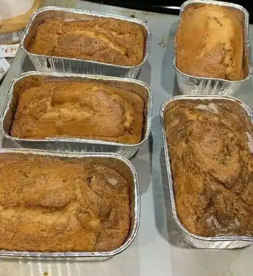 Slices of banana bread topped with melted butter and fresh banana slices