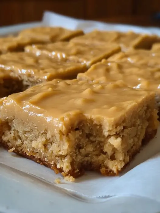 Slices of peanut butter sheet cake on a serving platter