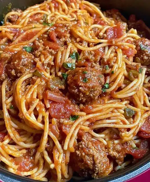 A beautiful platter of spaghetti topped with meatballs and fresh basil.