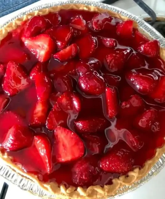 A perfect slice of strawberry cream pie with visible layers of crust, cream, and fruit