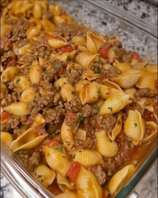 Finished cheesy beef and shells skillet garnished with fresh parsley