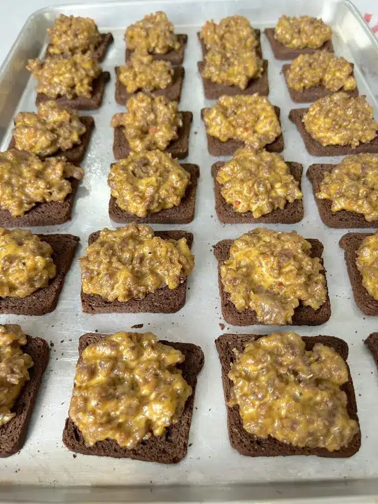 A platter of hanky panky bites garnished with fresh herbs