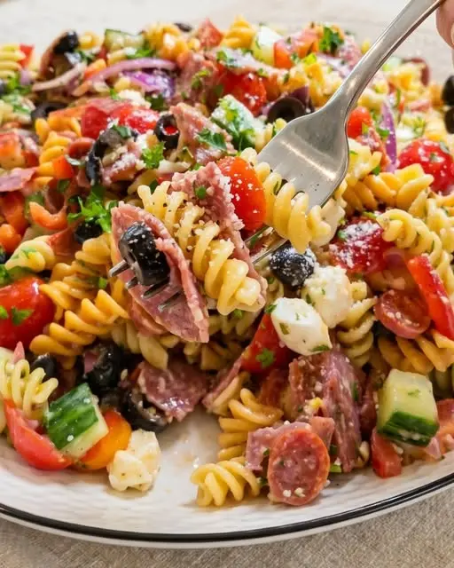 Close up of Italian pasta salad with herbs and parmesan cheese.