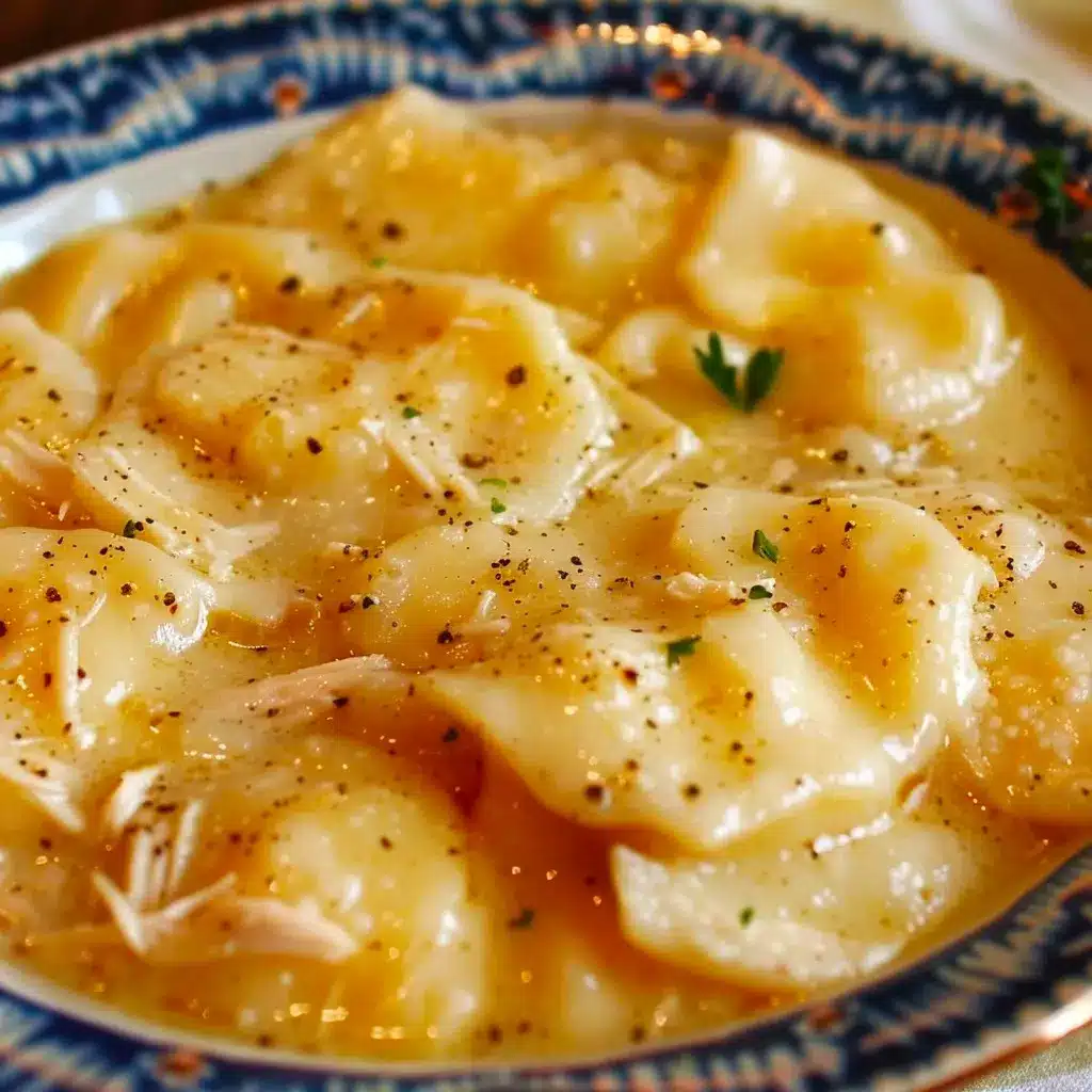 Close up of a spoonful of chicken and dumplings showing the thick broth and tender dough