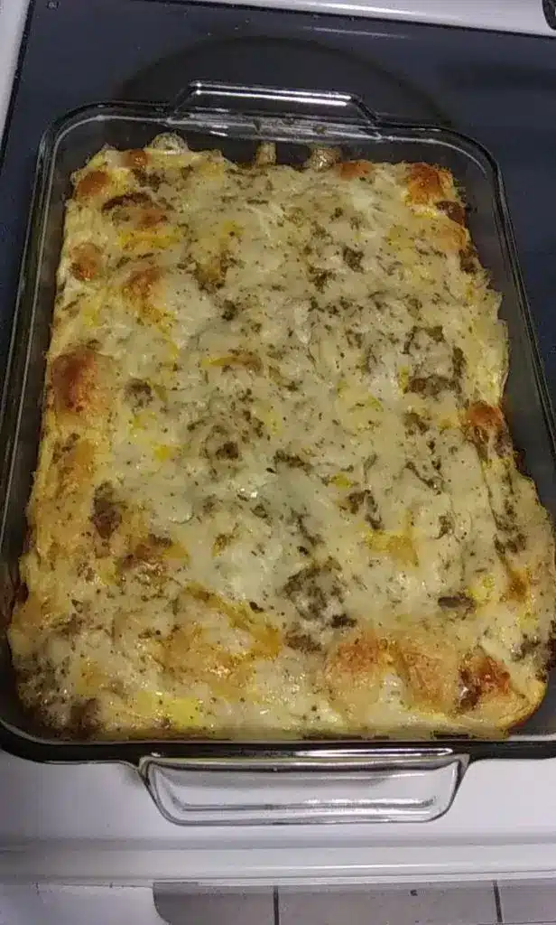 A serving of chicken biscuit casserole on a plate with a side of green beans