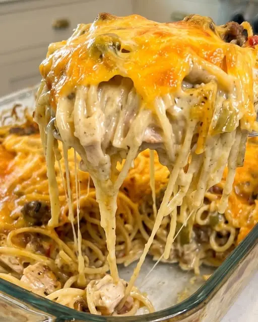 finished creamy crack chicken spaghetti bake served on a plate with green onions