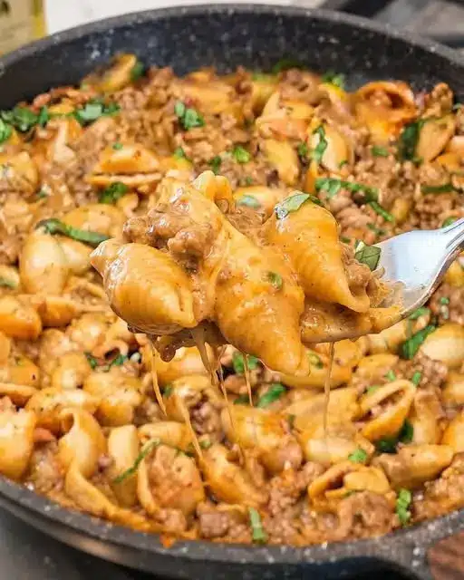 The finished creamy garlic parmesan beef pasta served in a bowl with a sprinkle of fresh parsley on top