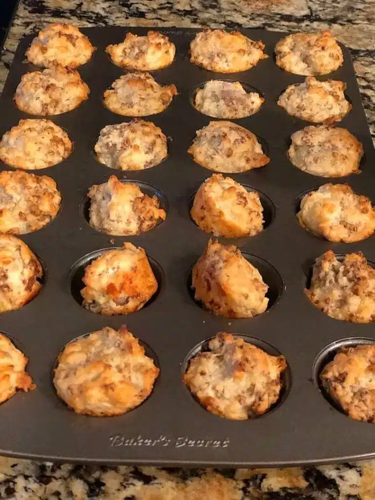A platter of crispy hash brown sausage bites garnished with fresh chives