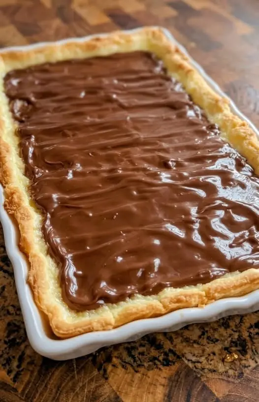 A close-up shot of a sliced piece of apple cinnamon bread showing a moist texture and plenty of apple chunks.