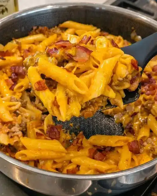 Finished bowl of bacon cheeseburger pasta topped with fresh parsley and bacon bits