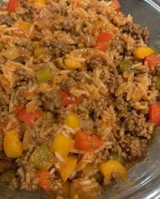 Close-up of a bowl of easy beef and vegetable rice topped with fresh green onions.