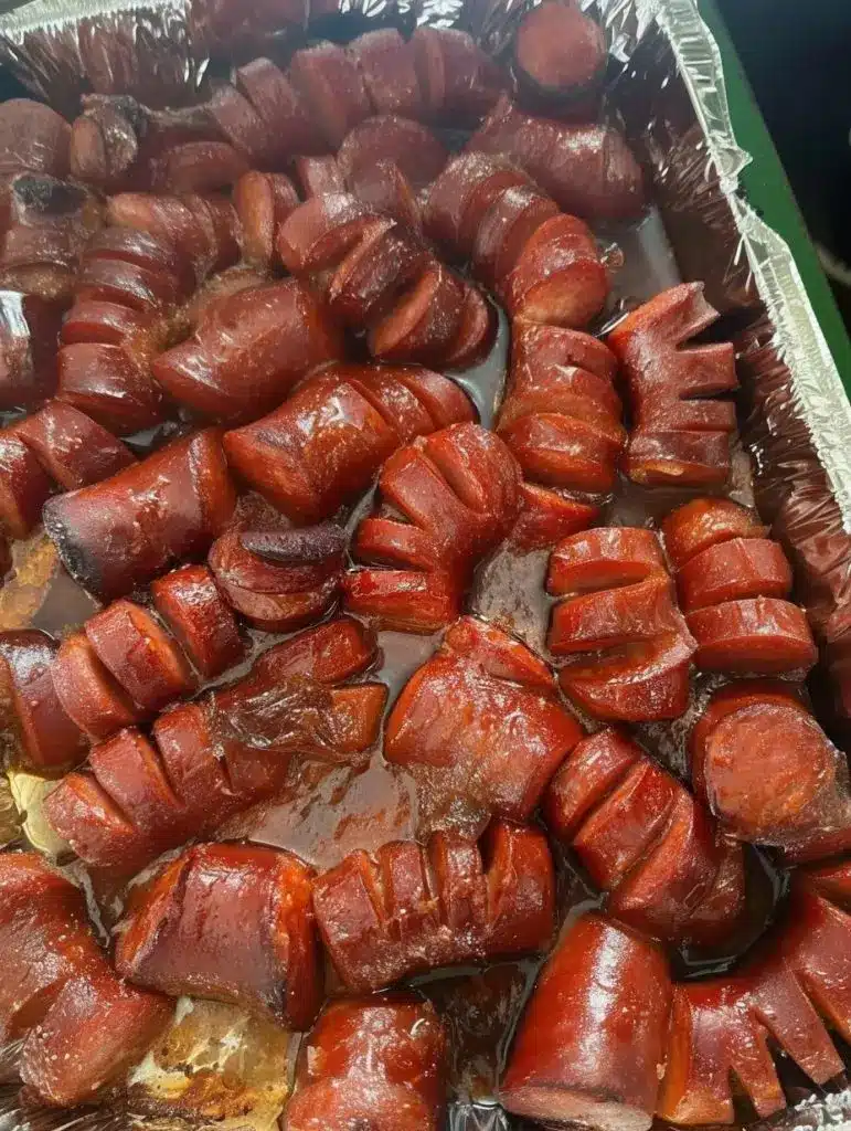 Platter of caramelized kielbasa bites with garnishes