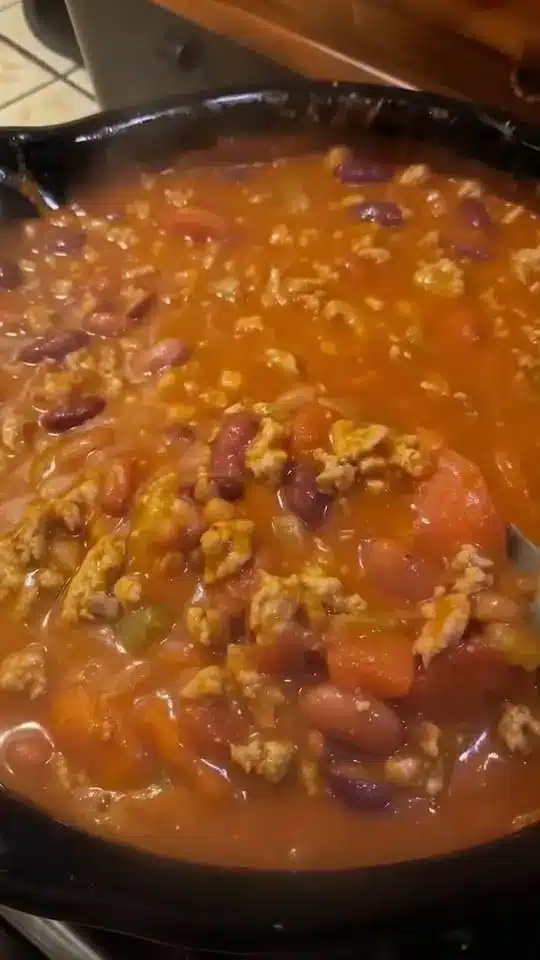 A serving of ground beef casserole on a white plate with a fork