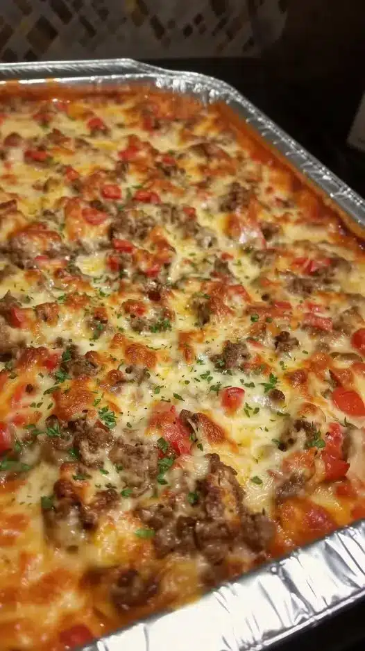 A serving of ground beef casserole with pasta and melted cheese on a plate