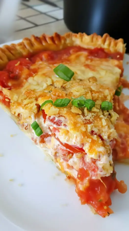 A serving of cheesy pizza pasta bake being lifted out of the pan with a spatula
