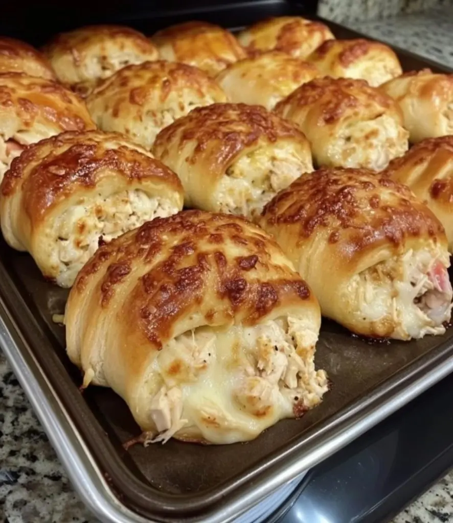 Two chicken crescent roll ups served with a side of dipping sauce