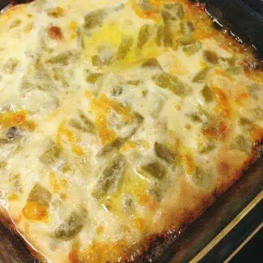 A slice of chile relleno casserole served with salsa and fresh cilantro