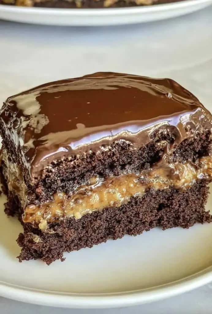 A whole chocolate turtle cake in a baking dish topped with plenty of pecans and caramel drizzle.