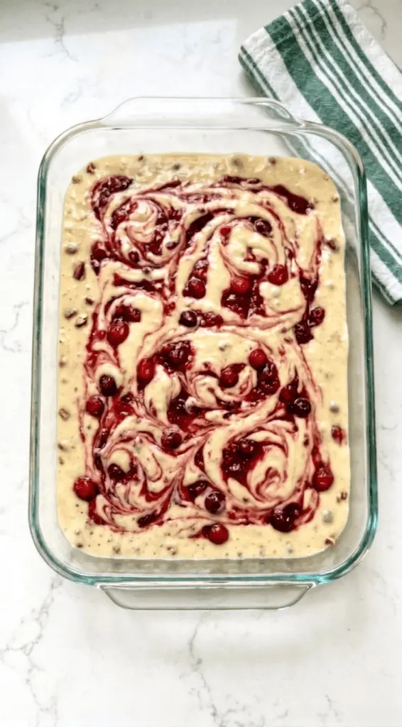 A finished slice of easy christmas chaos cake topped with whipped cream