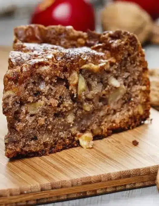 The whole cinnamon apple cake fresh out of the oven, showing a golden brown crust and apple pieces