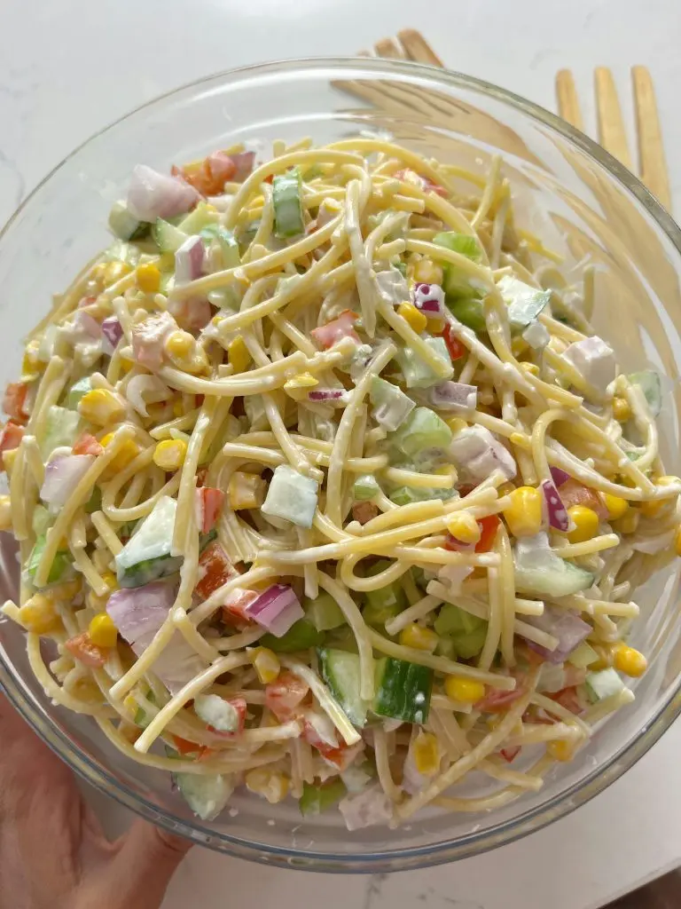 A close-up of the finished confetti salad showing the uniform dicing and glossy dressing.
