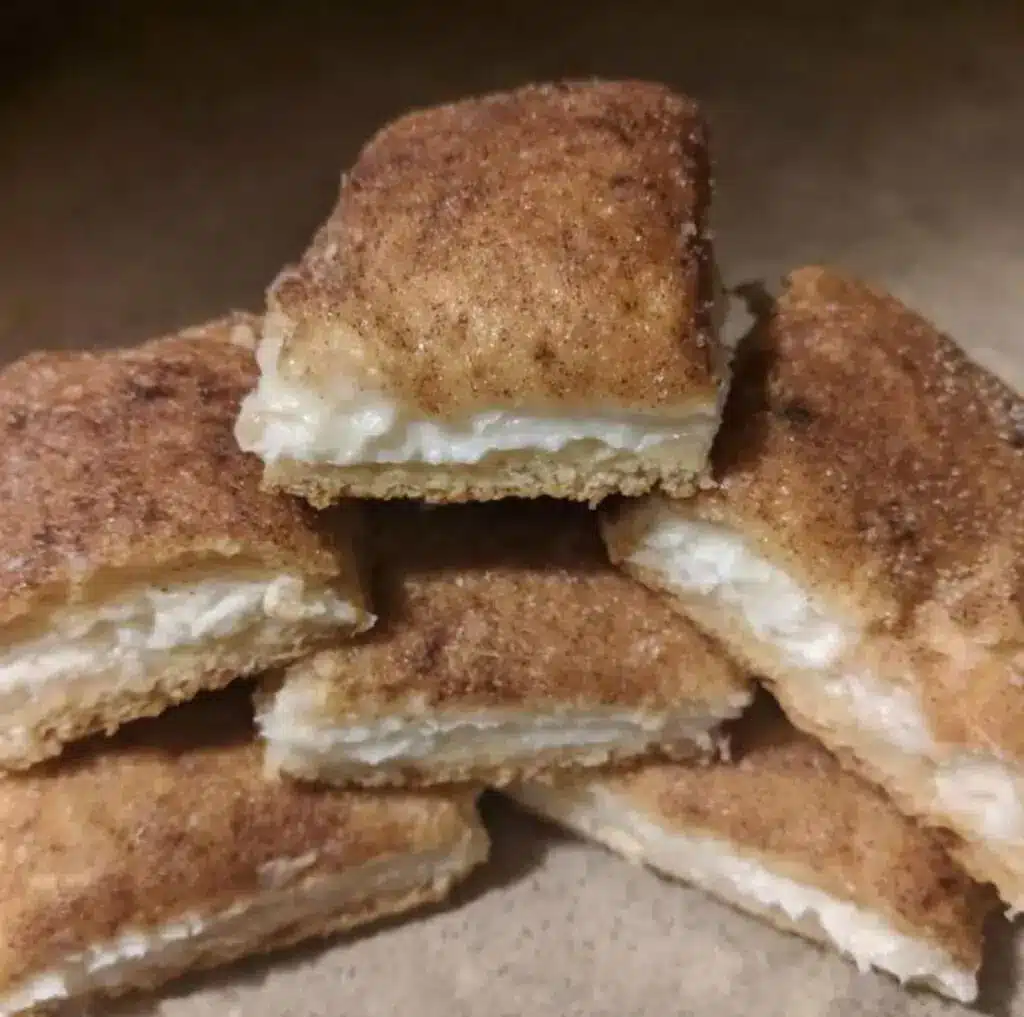 a close up of sliced cream cheese squares showing the flaky layers and creamy center