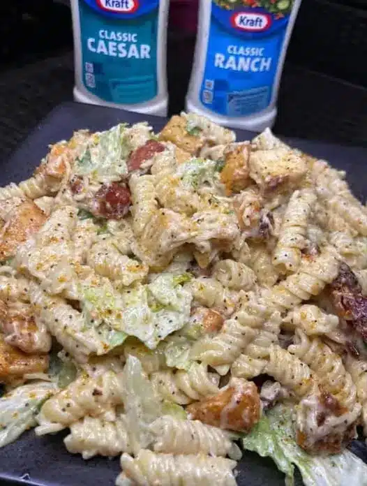 Close up of creamy ranch pasta salad showing the texture of the dressing and the colorful vegetable mix-ins.