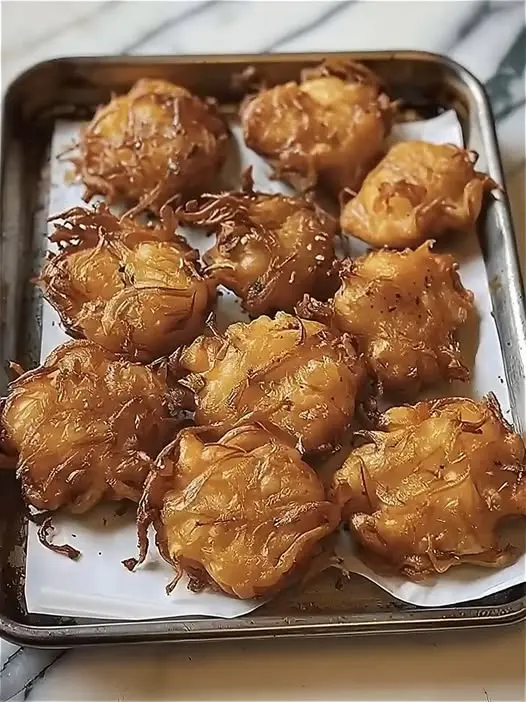 Freshly baked golden brown coconut macaroons on a cooling rack
