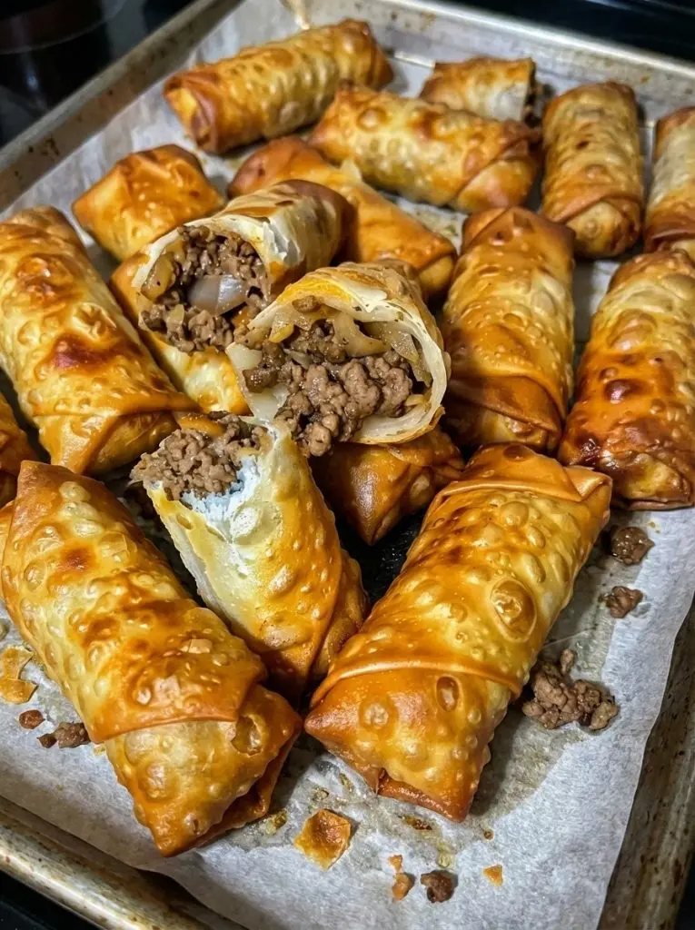 Slices of nacho egg rolls served with a side of creamy nacho cheese sauce and garnishes.