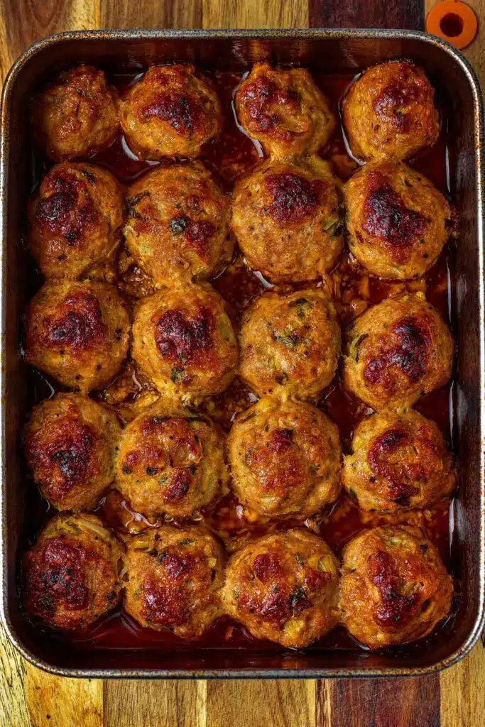 A serving of honey BBQ meatballs garnished with green onions.