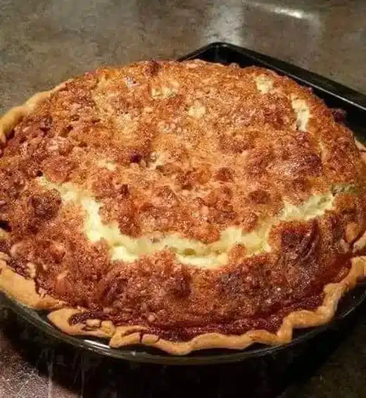 A slice of cheeseburger pie served on a plate with fresh garnishes.