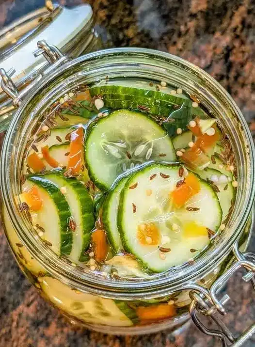 Spicy asian cucumber salad garnished with sesame seeds in a ceramic bowl