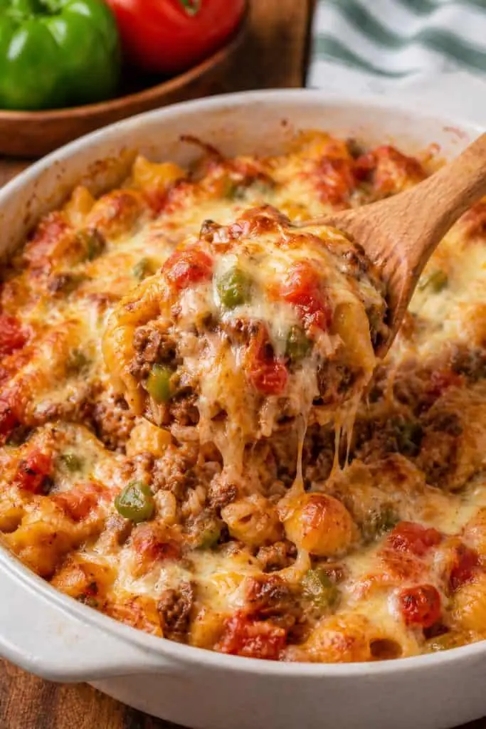 A bowl of stuffed pepper pasta topped with melted cheese and fresh herbs