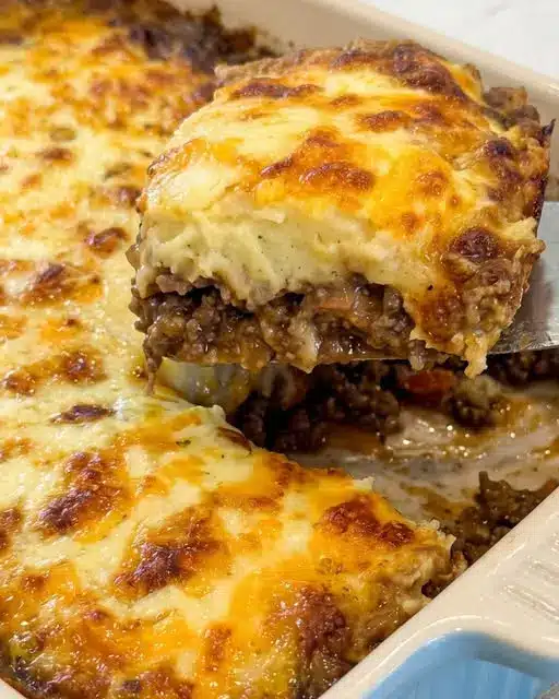 Finished french onion beef potato casserole with melted cheese and crispy onions