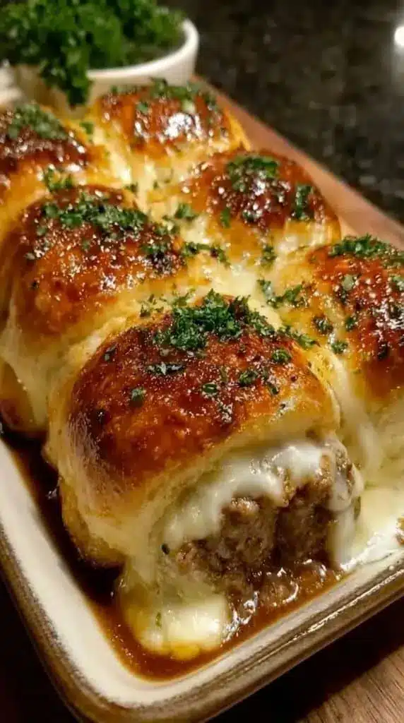 Finished garlic parmesan cheeseburger bombs served on a platter with dipping sauce